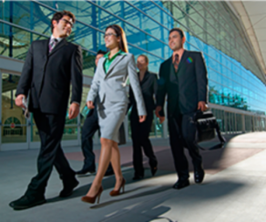 Professionals walking confidently together by a glass building